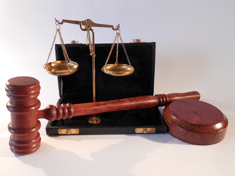 Law book, scale and hammer